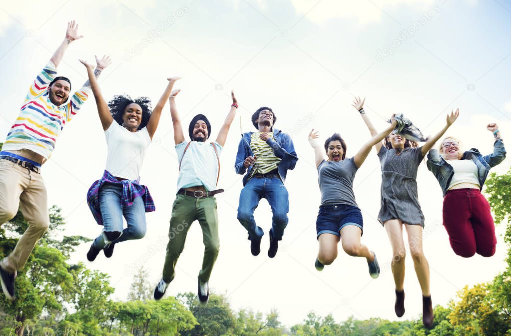 Diverse friends jumping in field, original photoset