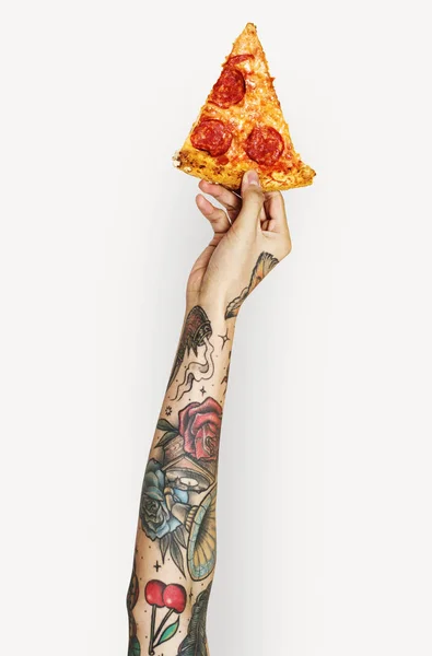 human hand with tattoos against white background holding pizza slice