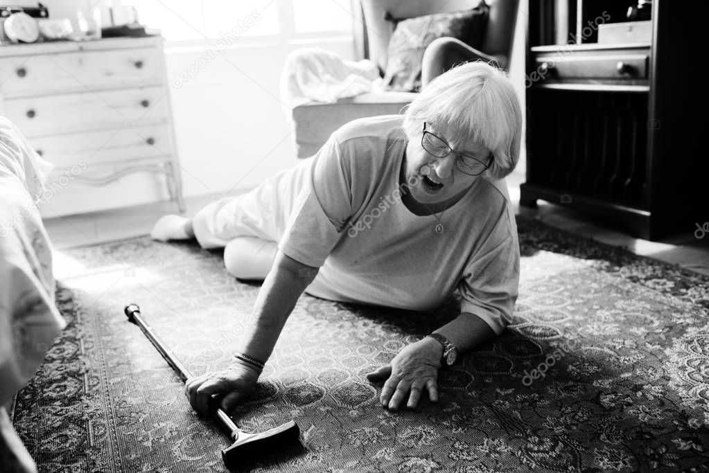 Elderly woman felling on the floor, black and white