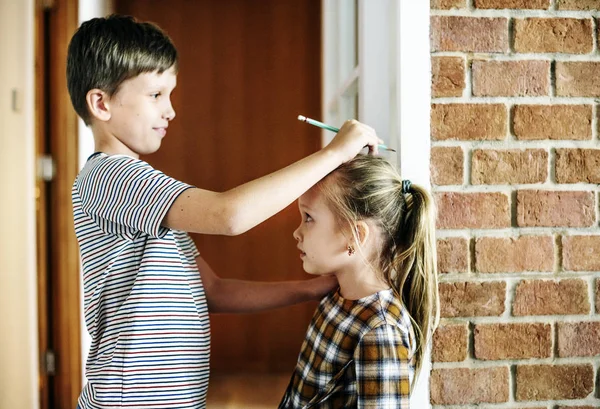 Older Brother Checking Growth Younger Sister — Stock Photo, Image