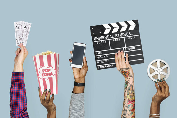 cropped image of people hands holding cinema stuff 