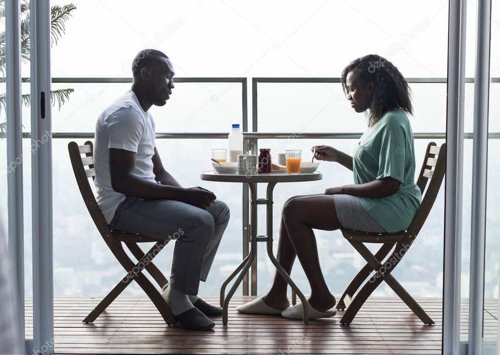Couple having breakfast together at the balcony