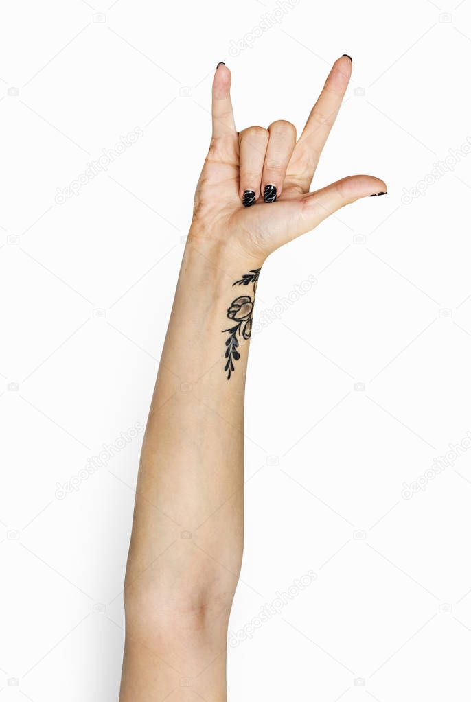 human hand gesturing rock symbol with fingers in studio, cropped image 