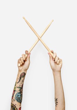 two hands holding drum sticks  clipart