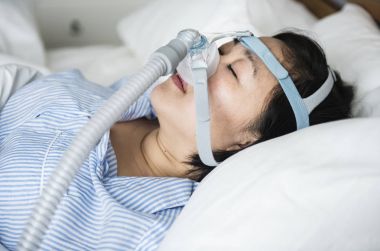 Asian woman wearing anti-snoring chin straps clipart