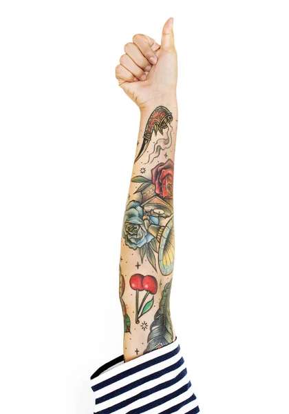human hand with tattoos gesturing like, thumbs up