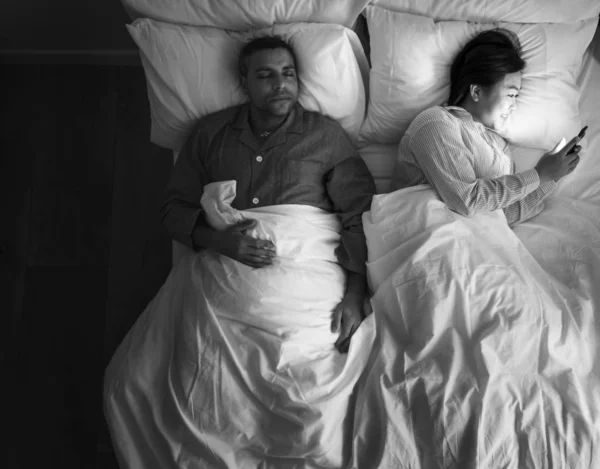 Interracial Couple Bed Woman Using Mobile Phone Black White — Stock Photo, Image
