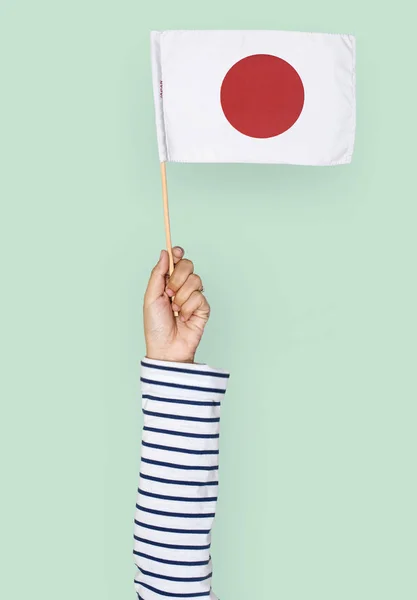 Mão Caucasiano Humano Segurando Bandeira Japonesa — Fotografia de Stock