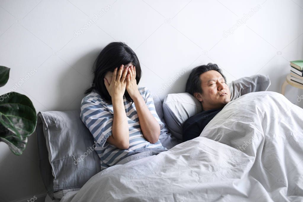 A sad Asian woman in an unhappy marriage