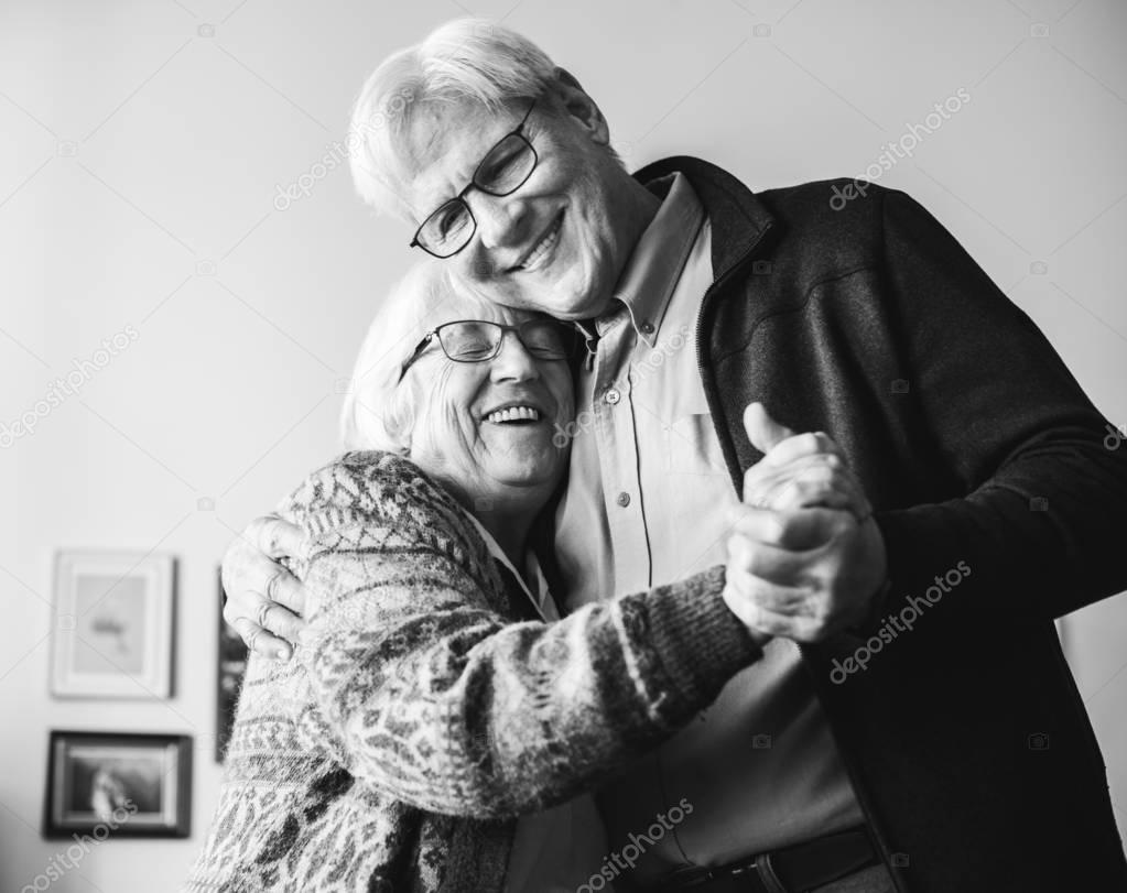 Black and white photo of senior couple dancing at home
