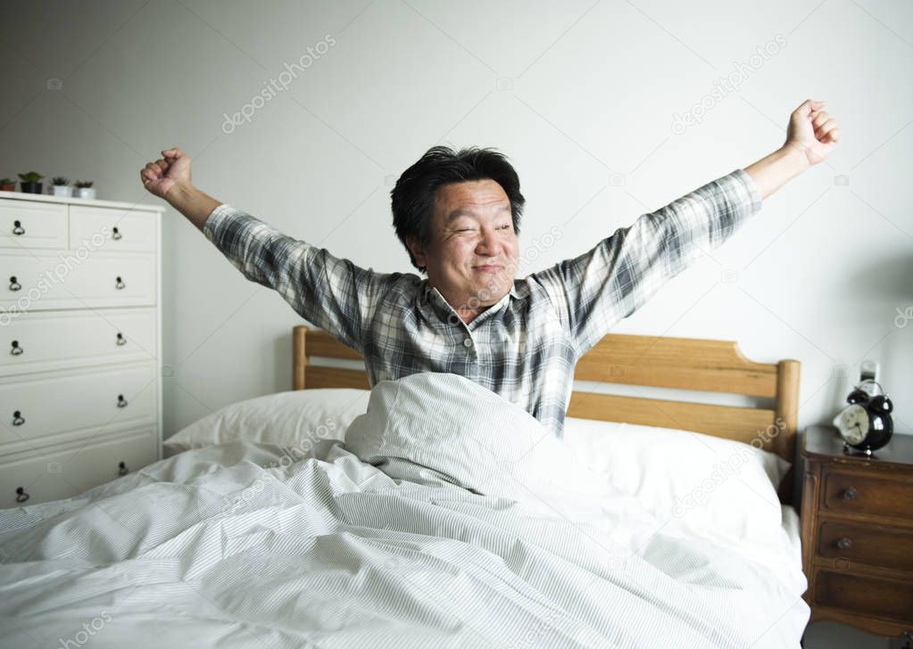 Asian man wake up in morning 