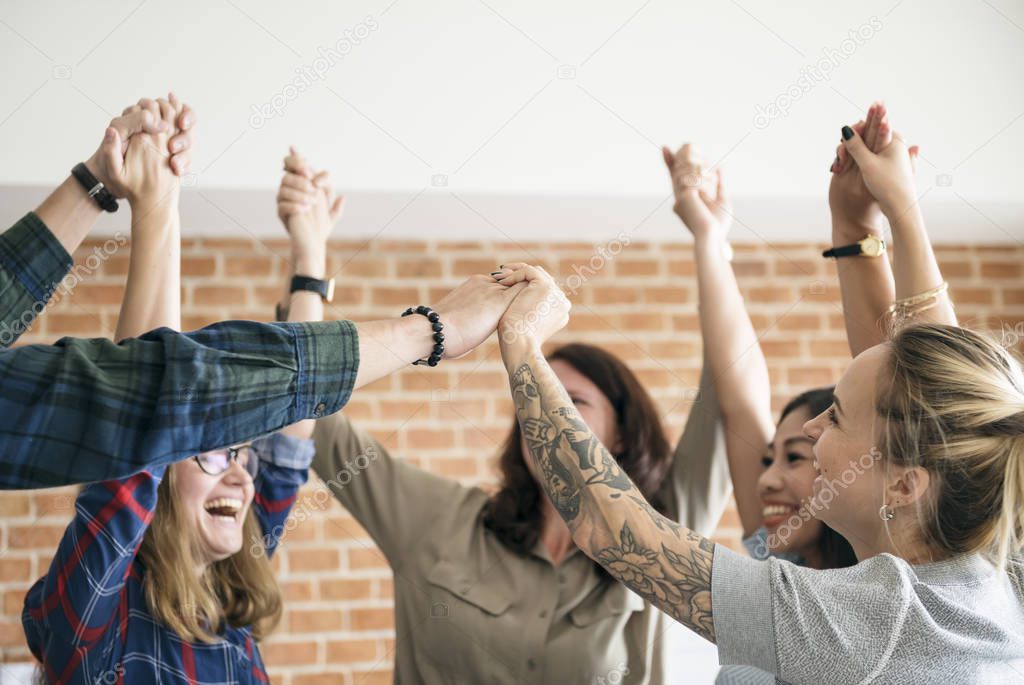 Business team raising their hands up to celebrate