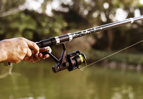 Man fishing on fishing rod in jungle