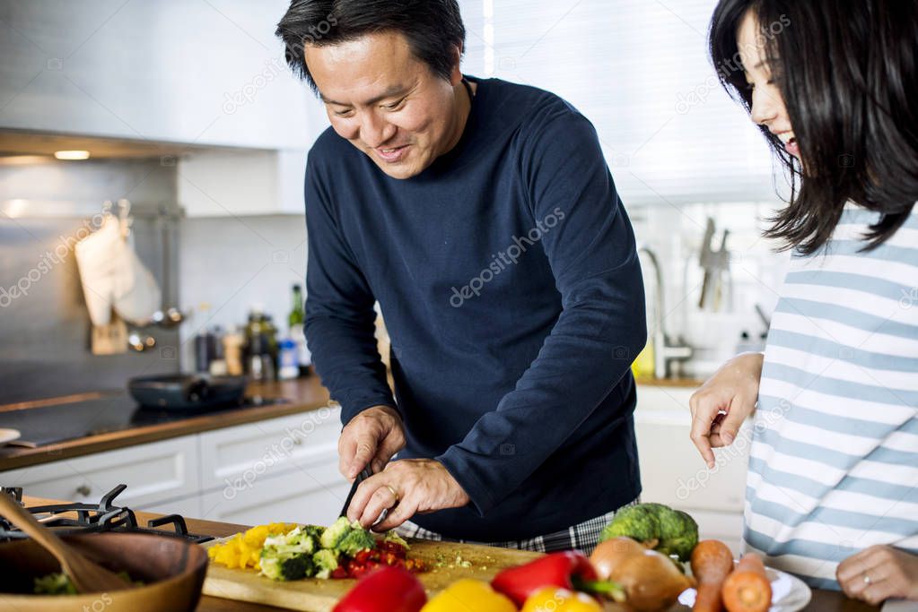 Asian couple cooking in the kitchen