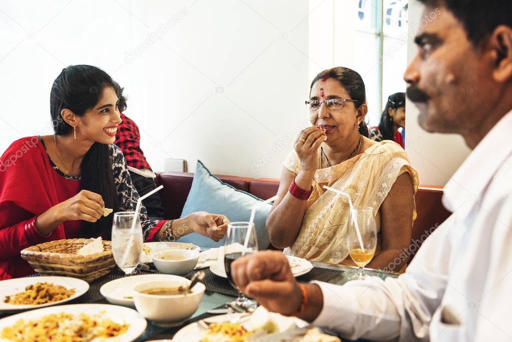 Indian family eating in restaurant 