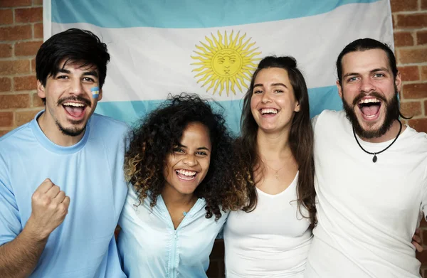 Friends cheering world cup with painted flag