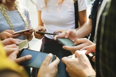 Genç Yetişkin arkadaşlar açık havada birlikte akıllı telefonlar kullanan, Gençlik Kültür kavramı