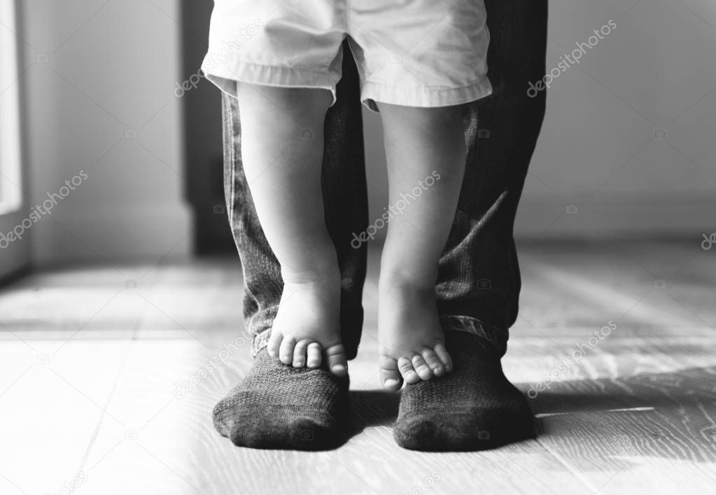 Father and son in room, black and white