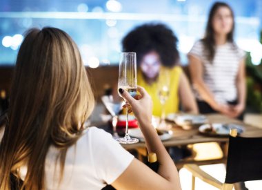 Genç Yetişkin bir çatı katındaki restoranda arkadaşlarınızla akşam yemeği