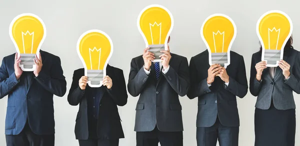 Business People Holding Lightbulb Icons — Stock Photo, Image