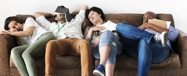 Diverse workers taking rest on couch