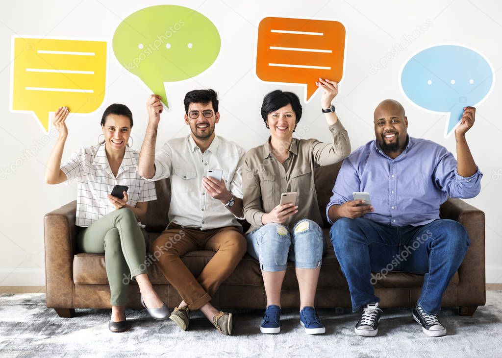Workers holding colorful speech bubbles and mobile phones