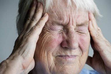 Elderly woman suffering from migraine clipart