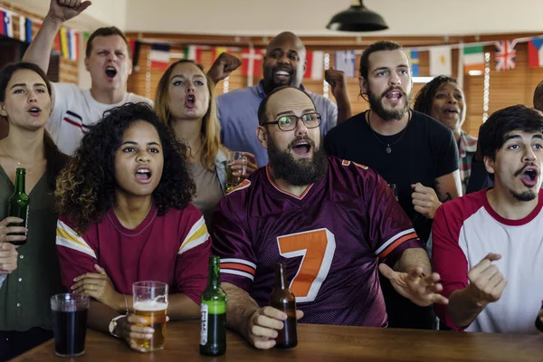 Frieds cheering sport at bar together