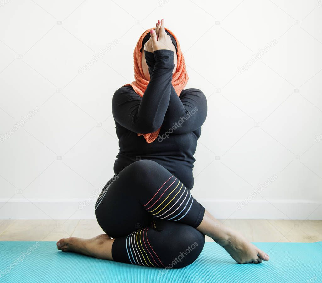 Islamic woman doing yoga in the room 