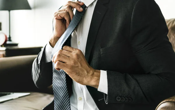 Businessman Adjusting Neck Tie Wearing Suit — Stock Photo, Image