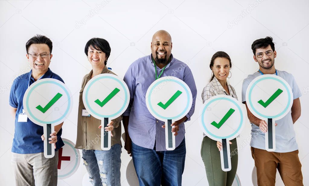 Workers standing and holding correct ticks logos