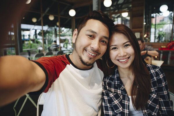 Happy couple taking selfie together