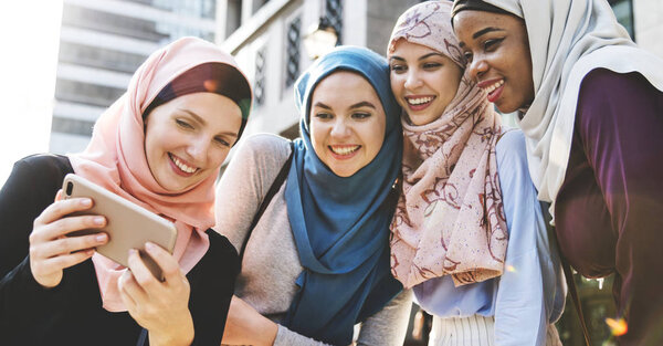 Group of islamic women looking at smartphone 