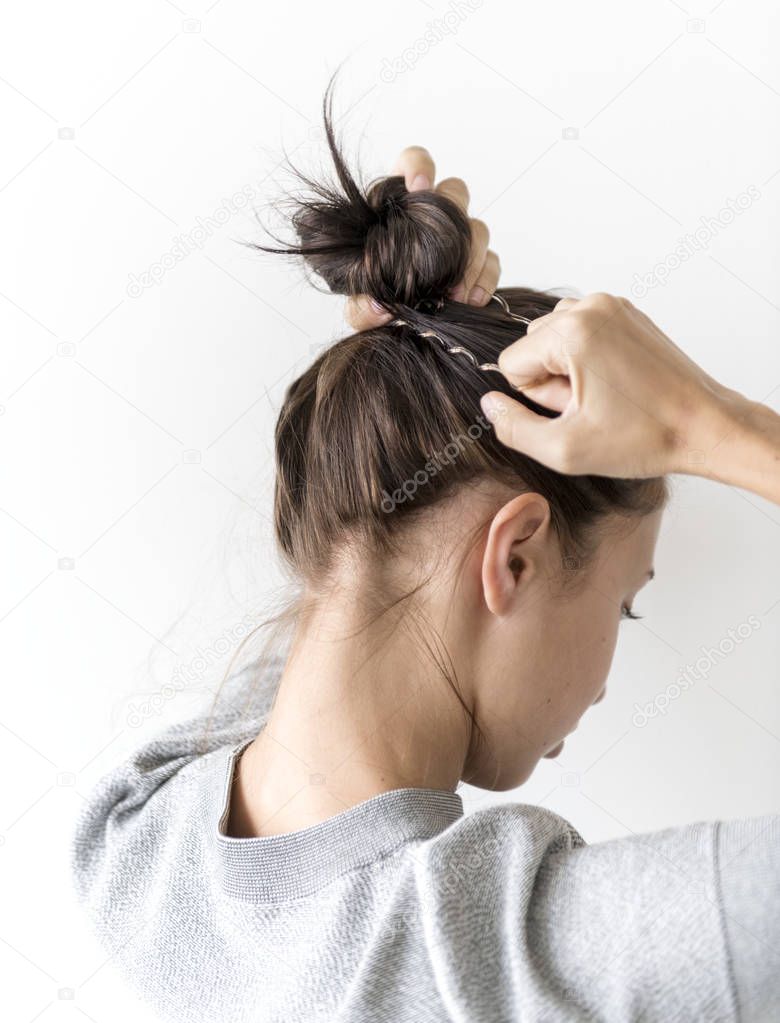 Woman making hair bun