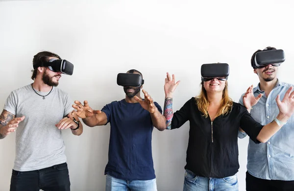 Group of divese friends experiencing virtual reality with VR headset