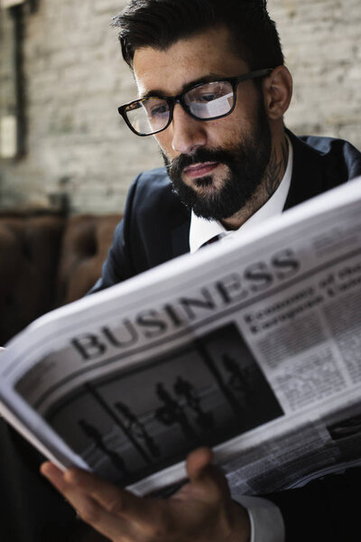 businessman in eye wear reading newspaper