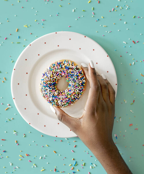Aerial view of hand getting donuts 
