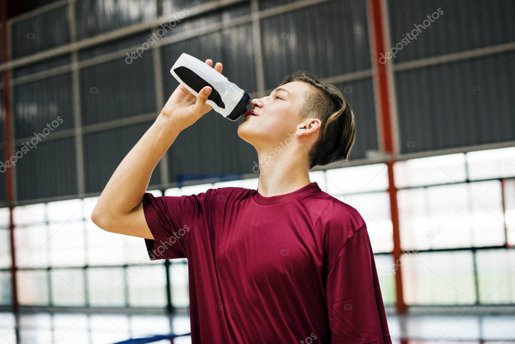 Young sporty man drinking sporty drink or water