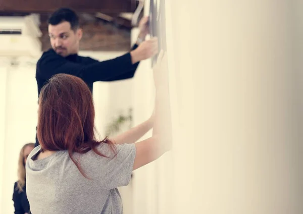 stock image Man taking care of frames in an exhibition