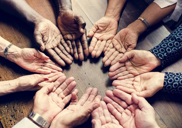 Group of diverse hands palms circle support together teamwork aerial view