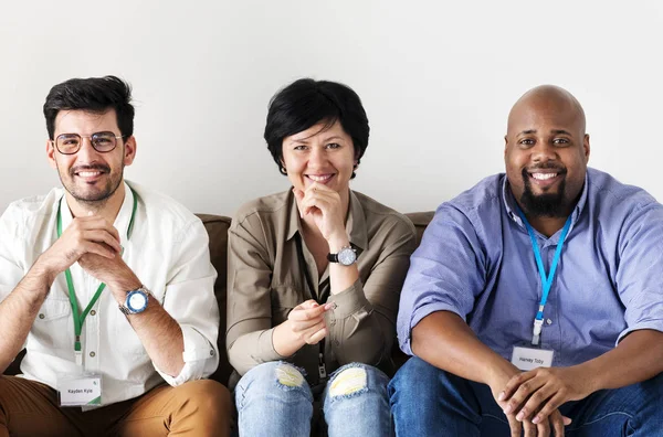 Diverse workers sitting together on couch