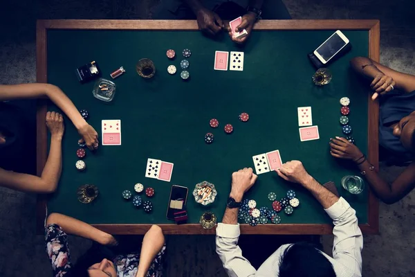 people playing poker at table in casino, top view