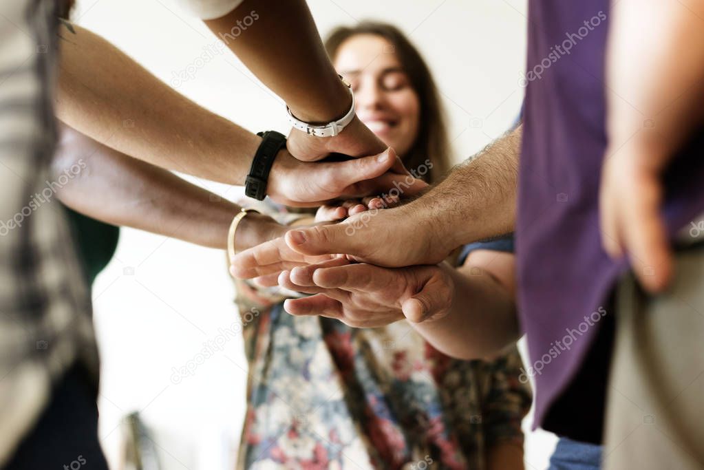 Group of diverse people joined hands together