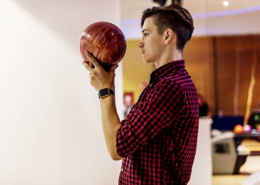 Boy about to roll a bowling ball hobby and leisure concept clipart