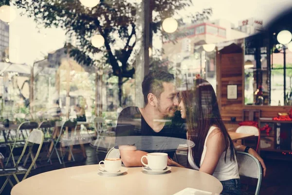 Lovely asian couple having coffee