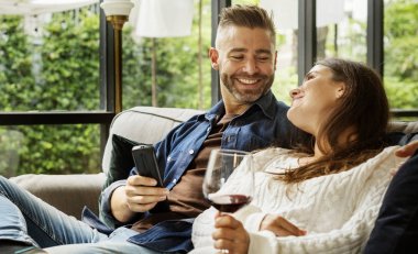 Cheerful couple spending time together, drinking wine  clipart