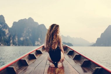 Beautiful woman posing on a boat clipart