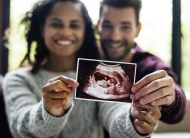 Happy couple with pregnancy news clipart