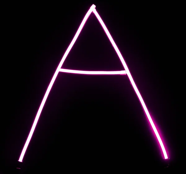 Alphabet pink neon lights on black background