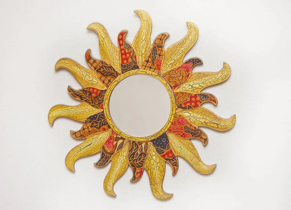 Golden mirror on the wall in the form of the sun. — Stock Photo, Image